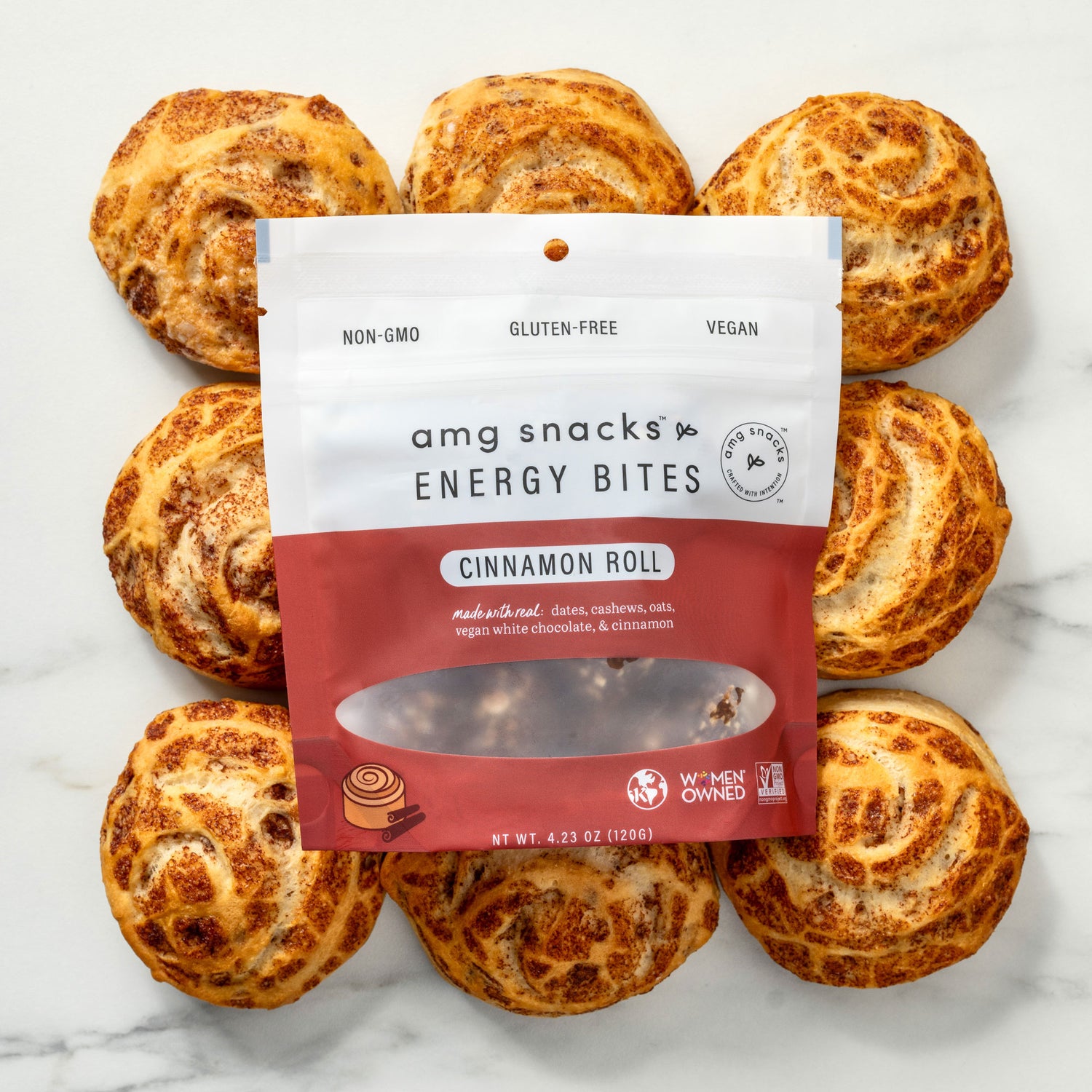 Cinnamon Roll energy bites over freshly made cinnamon rolls