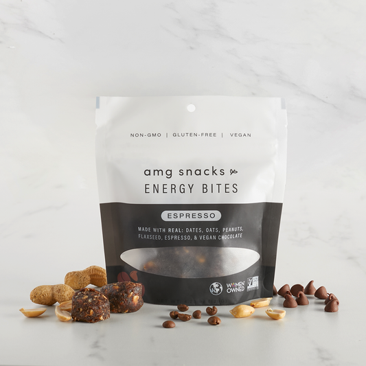 Espresso Bites with espresso beans, peanuts, energy bites on marble background.