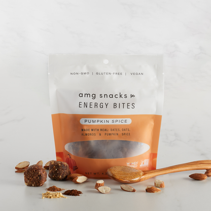 Pumpkin Spice Energy Bites with almond pieces on marble.