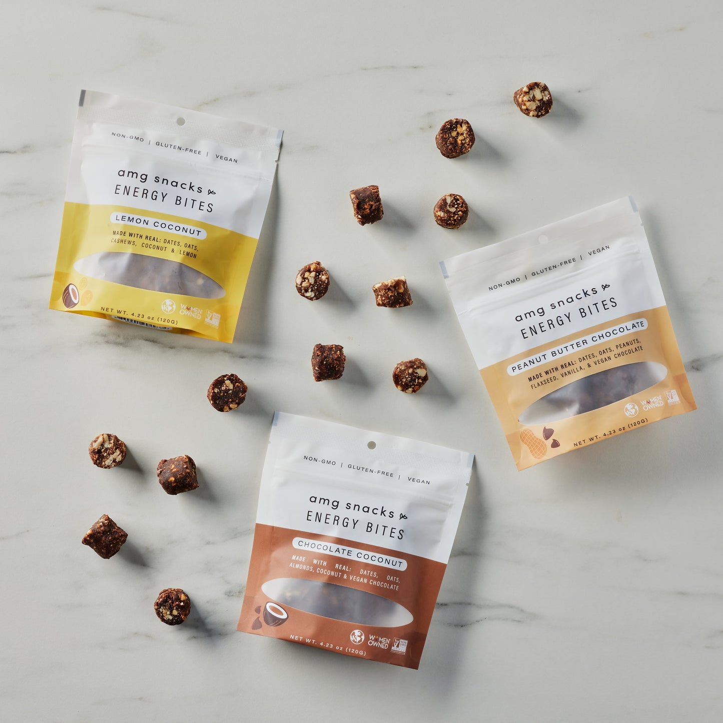 Chocolate Coconut, Peanut Butter Chocolate, and Chocolate Coconut Energy Bites on marble with energy bites scattered.
